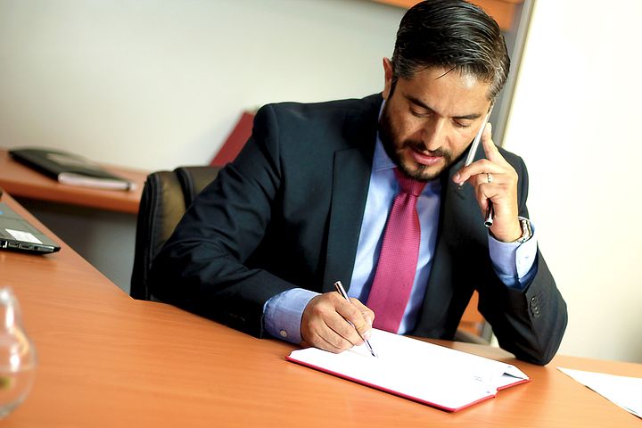migration lawyer talking to a client over the phone